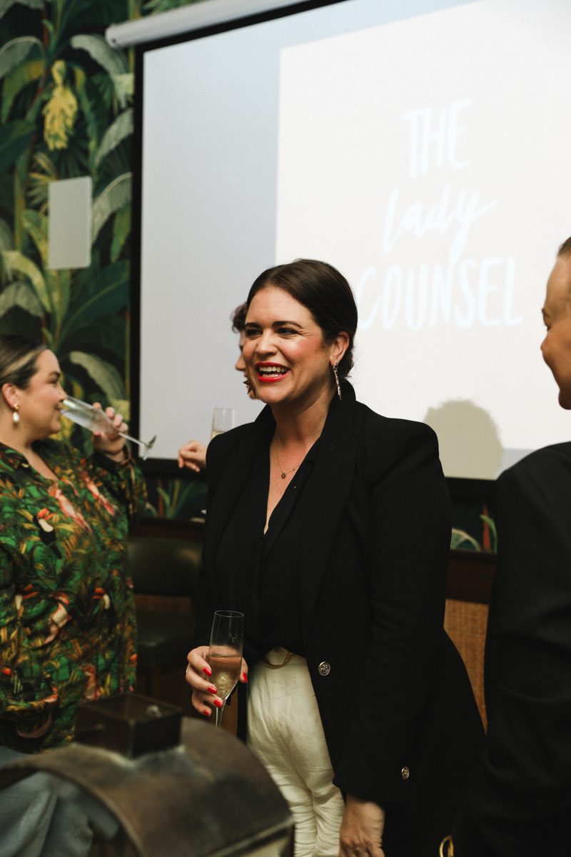 Chatting with guests in front of The Lady Counsel screen