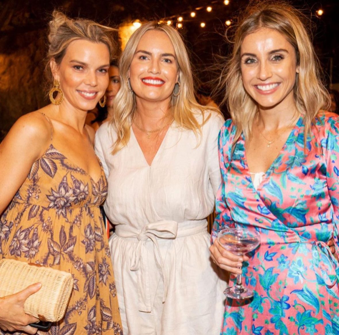 Three guests smiling together at an evening Lady Counsel event