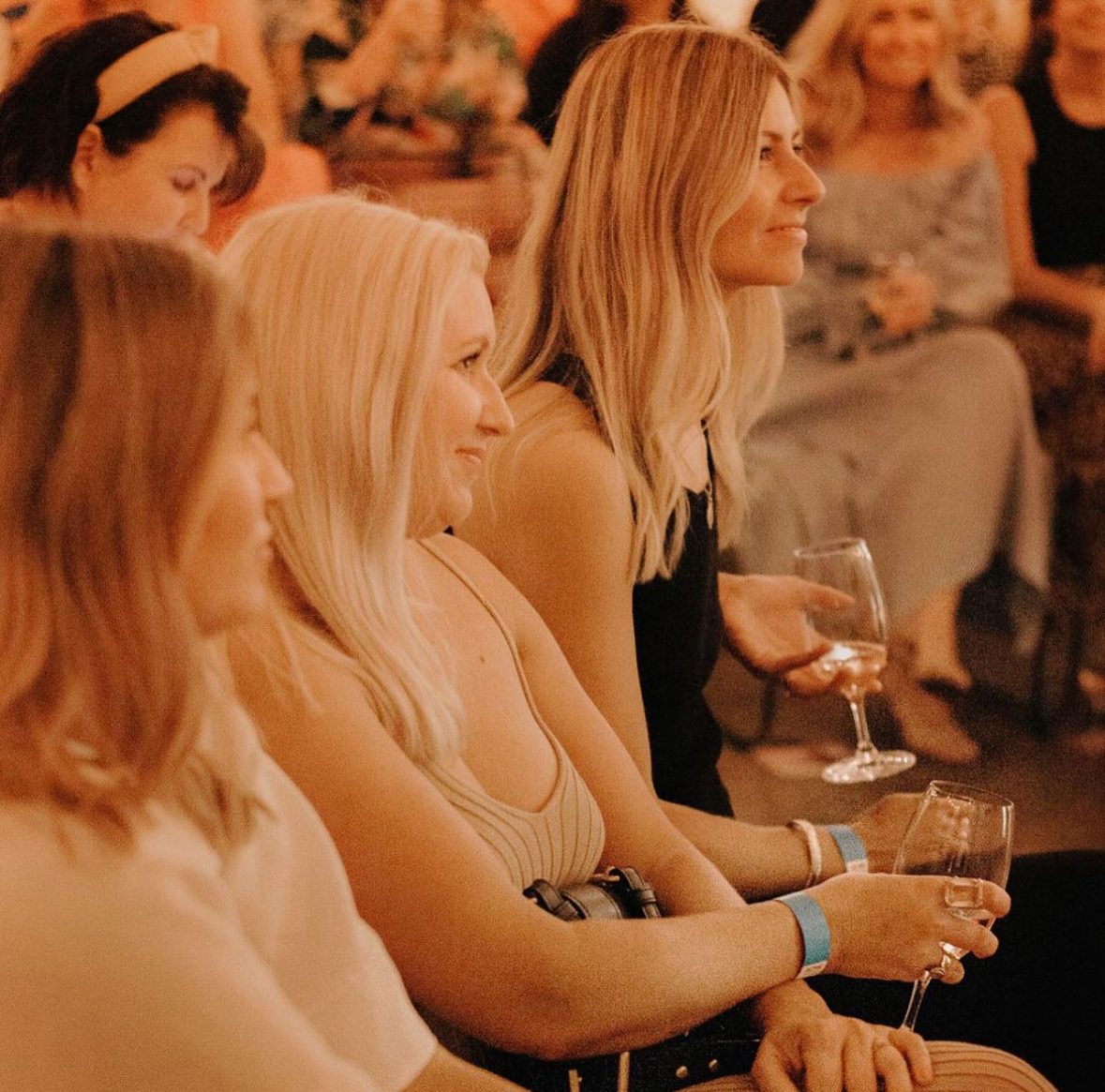 Guests smiling in the audience during a talk