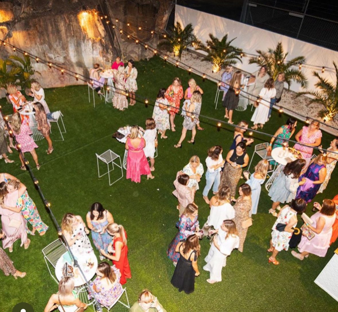 Overhead view of guests mingling at an evening garden party